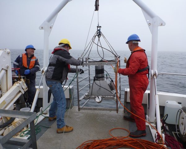 image of three people on a ship