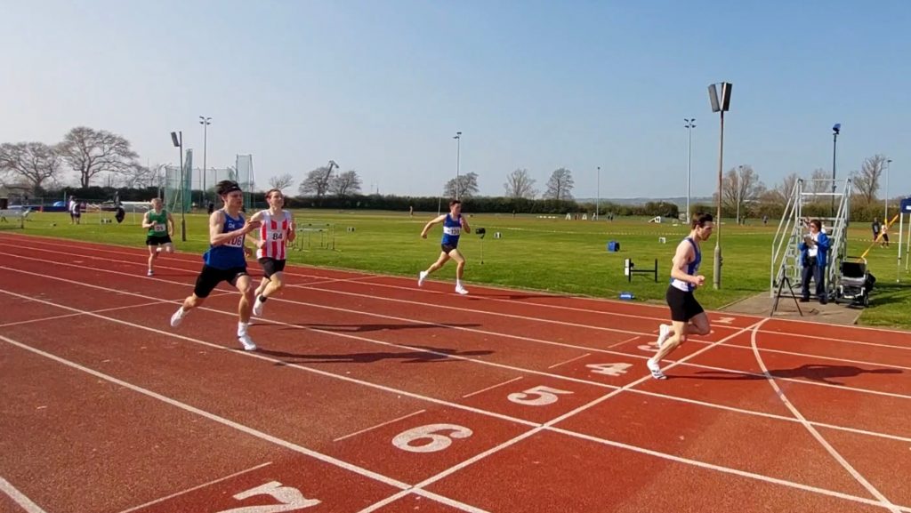 Aston Lockwood crossing the finish line of an athletics track