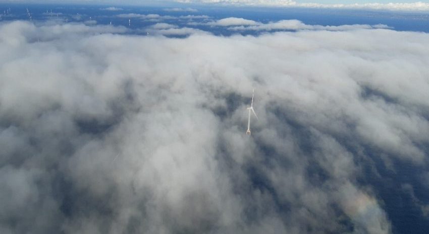 Wind turbine from above clouds